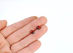 so cute and so realistic!tiny ladybug stud earringsjust the size of the real ladybugsterling silver post and a closure, a copper bug, coated with enamel (both sides, so the earring is non allergic)red enamel gets the most vibrant shade when combined with coppereach bug is hand painted with a tiny brush, each pair of earrings is unique Funky Stud Earrings, Ladybug Earring, Insect Earrings, Unique Stud Earrings, Ladybug Earrings, Ladybug Jewelry, Dope Jewelry Accessories, Unique Studs, Cute Stud Earrings