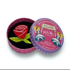 a pink and purple tin with a rose in it