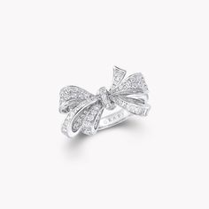 Featuring a playful bow motif set with round and baguette cut diamonds, our charming ring from the Tilda’s Bow collection captures the beauty of a silk bow, freshly tied by hand. Recreated in shimmering rows of diamonds set in white gold, each of the baguette cut stones has been individually cut by hand to fit the delicate curves of the design. An enduring influence on the House of Graff, our latest, entirely lifelike interpretation of the bow has inspired a whole collection of jewels, including Luxury Silver Jewelry With Bow, Luxury Silver Jewelry With Bow Detail, Luxury Diamond Bow Jewelry, Luxury Bow Jewelry For Anniversary, Elegant Diamond Jewelry With Bow Detail, Elegant Diamond Rings With Bow Detail, Diamond Ring With Bow For Gift, Diamond Bow Jewelry For Weddings, White Gold Bow Rings For Wedding