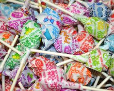 many colorful candies are stacked on top of each other