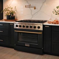 a stove top oven sitting inside of a kitchen next to wooden cabinets and counter tops