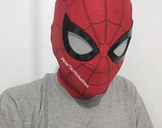 a man wearing a spiderman mask with the words'deadpool'written on it