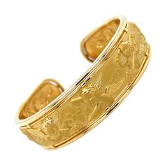 Beautiful piece of art crafted by famed designer Carrera Y Carrera. This cuff bracelet is crafted in 22k & 18k yellow gold and depicts cherubs happily playing instruments in a heavenly back ground. As most of Carrera Y Carrera pieces, this cuff shows multiple polish textures. The center portion with the cherubs is crafted in 22k gold and displays a satin finish. The border of the cuff shows a high polish finish which contrast perfectly, highlighting the cherub design. The cuff measures 17 mm in width and will fit a 7" inch wrist. The cuff is fully hallmarked by the designer with serial number "326826" and Carrera Y Carrera's makers mark. The cuff weighs 23.9 grams and will arrive to you in pristine condition as it was recently polished by our in house jeweler. All photos taken under magnif Cherub Design, Gold Cuff Bangle, Angel Cherub, Spanish Art, Gold Cuffs, Cuff Bangles, 22k Gold, Satin Finish, Cuff Bracelet