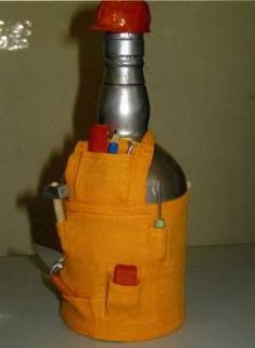 an orange bottle holder with tools in it