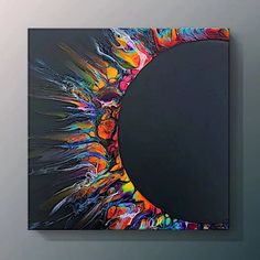 an abstract painting on a wall with a circular hole in the center and colorful paint splatters all over it