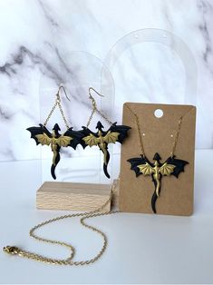 These handmade dragon earrings are one of a kind! They are lightweight and comfortable to wear all day long! All metal in earrings and necklace are surgical stainless steel so they are tarnish resistant and hypoallergenic. Care Instructions: Try not to excessively bend or stress earrings. Don't sleep, swim, work out, etc. while wearing them. Handmade in Kansas :) Black Jewelry For Halloween Fantasy Events, Themed Black Metal Jewelry, Gothic Gold Jewelry For Cosplay, Themed Black Jewelry As Gift, Themed Black Jewelry Gift, Black Dragon Design Jewelry Gift, Black Jewelry With Dragon Design For Gift, Black Metal Jewelry For Fantasy Events, Handmade Black Jewelry For Cosplay