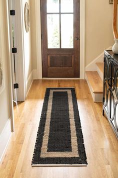 a black and white runner rug in front of a door