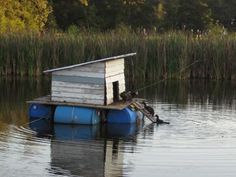 a boathouse floating on top of a body of water