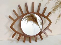 Dark brown small eye-shaped mirror, designed as an eye with eyelashes, makes for a charming Boho wall hanging. This Eye of Providence is a little aesthetic art piece, perfect for adding evil eye decor to your space. With a round mirror in the center, this decorative mirror blends style and symbolism. A cute bohemian piece, it serves as a small wall mirror with a wood framed mirror design, available as a colored mirror to complement any room. ➤SIZE 1 Frame with eyelashes 13.8*13 inches (35*33 cm) Aesthetic Evil Eye, Round Wooden Mirror, Mirror Dark, Evil Eye Decor, Boho Mirror, Eye Of Providence, Small Wall Mirrors, Colored Mirror, Handmade Mirror