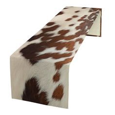 an animal print table runner is shown in brown and white