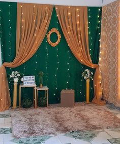 a stage set up for a wedding with lights on the walls and gold drapes