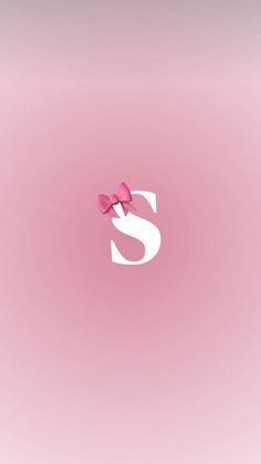 the letter s has two pink bows on it