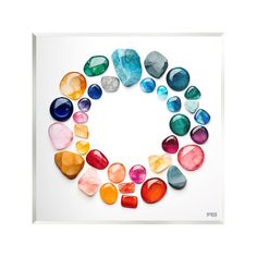 an image of colorful stones arranged in the shape of a circle on a white background