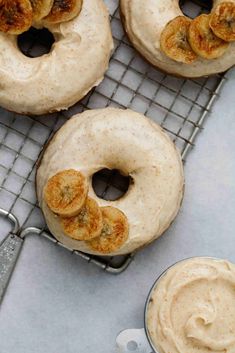 three doughnuts sitting on top of a cooling rack