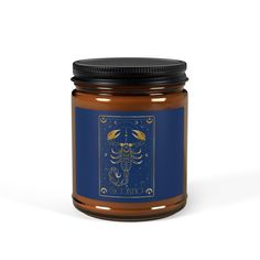 a jar filled with honey sitting on top of a white table