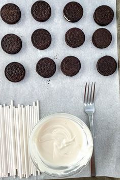 there are chocolate cookies and cream on the table next to each other with forks in front of them