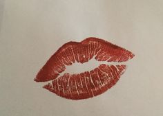 a drawing of a red lipstick on white paper