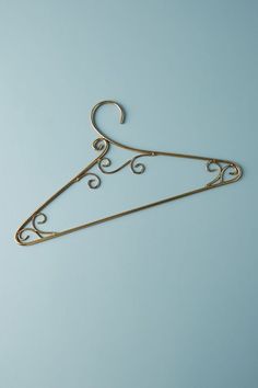 a gold metal hanger on a blue background