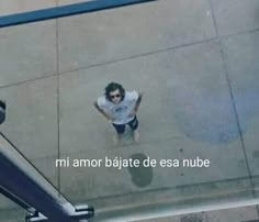 an aerial view of a man walking down the street in shorts and a t - shirt