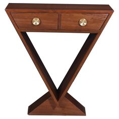 a wooden table with two drawers on one side and gold knobs on the other