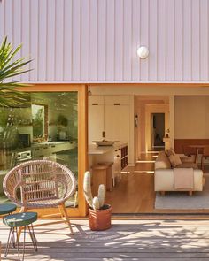 an outdoor living area with chairs, tables and couches