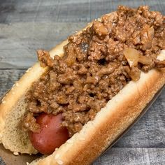 a hot dog with chili and onions on it