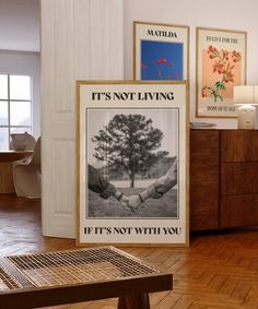 there is a poster on the wall in this living room that says it's not living if it's not with you