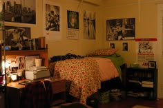 a bed room with a neatly made bed and lots of pictures on the wall above it