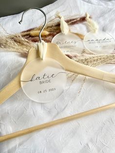 two wooden hangers with personalized names on them and some jumbo - twine