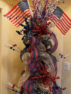 a patriotic wreath with red, white and blue decorations