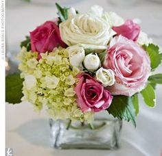 a vase filled with pink and white flowers