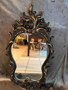 a mirror sitting on top of a table next to a wall