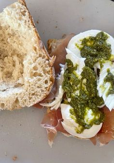 an open faced sandwich with pesto on it