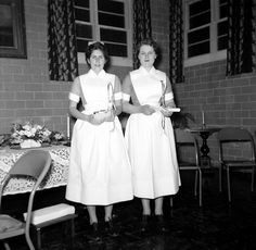 two women standing next to each other holding tennis racquets