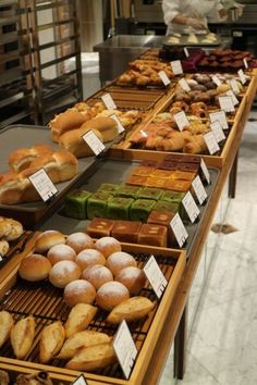 a display case filled with lots of different types of doughnuts and pastries