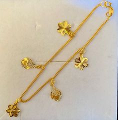 Daisy Charms Bracelet 916 Gold  Gold Purity : 916 GOLD  Weight : 3.77 grams  Appx Length: 7 inches  Appx Bracelet Size : width 1mm (please see pic with ruler) Appx Charm Size : width 0.8mm (please see pic with ruler) Colour : YELLOW GOLD Hallmark : Hallmarked 916 (916 Stamp) Hook :  lobster hook  Design : 5 Heart Charm Bracelet FAQs Q: Is it real gold? A: yes it's real authentic genuine 916 gold  Q: can pawn? A: yes it's pawnable ⭐️GoForGold⭐️ Gold Plated Bracelet With Dangling Charms, Gold Elegant Charm Bracelet, Elegant Gold Bracelets With Dangling Charms, Luxury Gold Bracelet With Dangling Charms, Real Gold Bracelet, Luxury Gold Antique-style Charm Bracelet, New Gold Jewellery Designs, Gold Jewellry, Daisy Charm