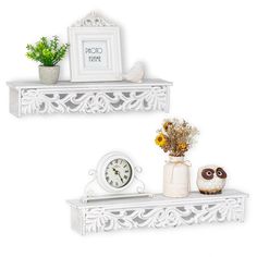 two white shelfs with flowers, an owl and a clock on them are shown