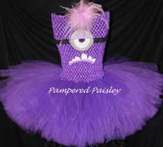 a purple dress with a monster face on the front and pink tulle around the waist