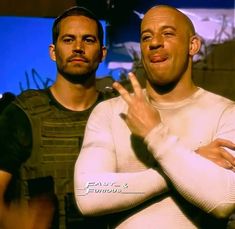 two men standing next to each other in front of a blue screen with the words fast and furious on it