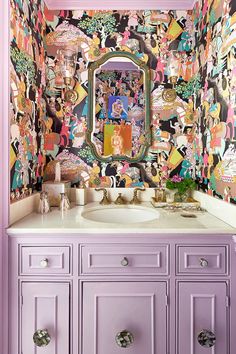 a bathroom decorated in pink, yellow and purple with lots of cartoon characters on the wall