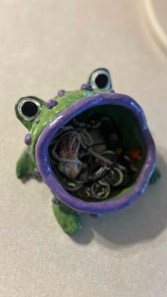 a frog figurine sitting on top of a table