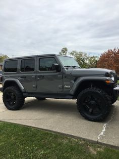 a gray jeep parked in a parking lot