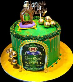 a green and yellow birthday cake with an apple on top