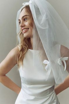 a woman wearing a white veil and dress