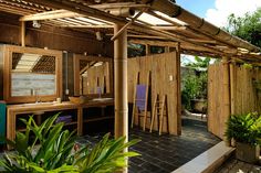 an outdoor area with wooden structures and potted plants