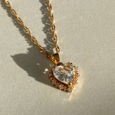 our bestselling crystal heart necklace is available in 5 gorgeous shades on a 18k gold plated wave chain which glistens to add some extra sparkle. each heart pendant is encrusted with cubic zirconia gems. material: 18k gold plated on brass. length: 40cm + 5cm adjustable. Gold Crystal Necklace, Crystal Heart Necklace, Neck Jewellery, Fancy Jewellery