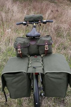 the back end of a bike with two bags on it