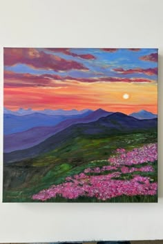 a painting of pink flowers on a mountain at sunset with the sun in the distance