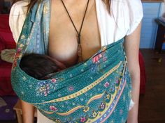 a woman wearing a baby sling wrapped around her breast is shown in an instagramtion photo