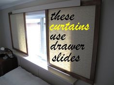 there are two windows with words on them in the window sill next to a bed